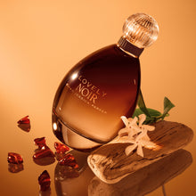 Sarah Jessica Parker Lovely Noir eau de parfum bottle surrounded by jasmine, amber and sandalwood
