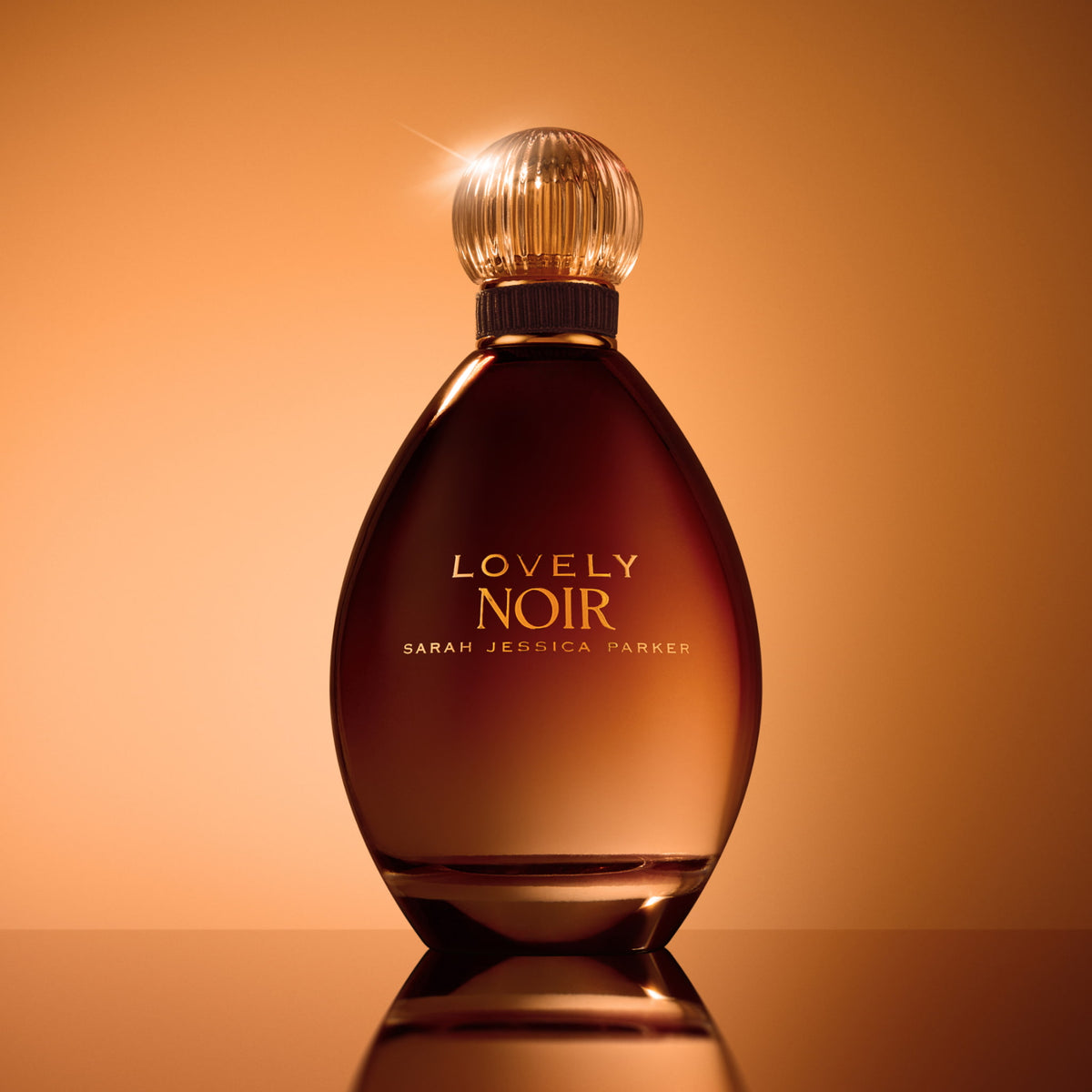 Sarah Jessica Parker Lovely Noir eau de parfum bottle in an elegant still life setting